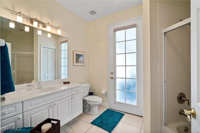 full bathroom with tile patterned flooring, vanity, combined bath / shower with glass door, and toilet