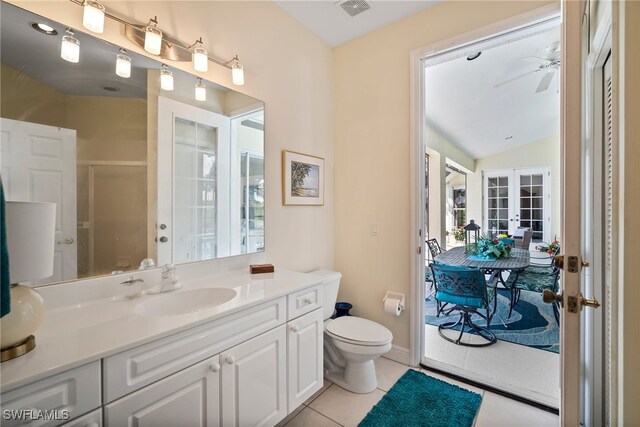 bathroom with french doors, toilet, vanity, ceiling fan, and tile patterned flooring