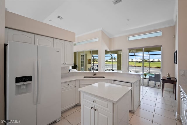 kitchen featuring sink, white cabinetry, a center island, ornamental molding, and white appliances