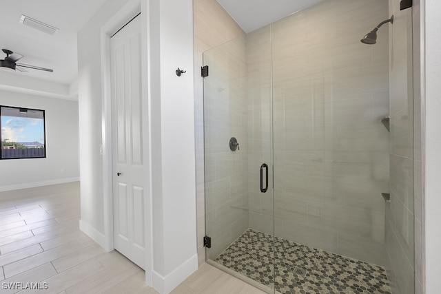 bathroom featuring walk in shower, tile patterned floors, and ceiling fan