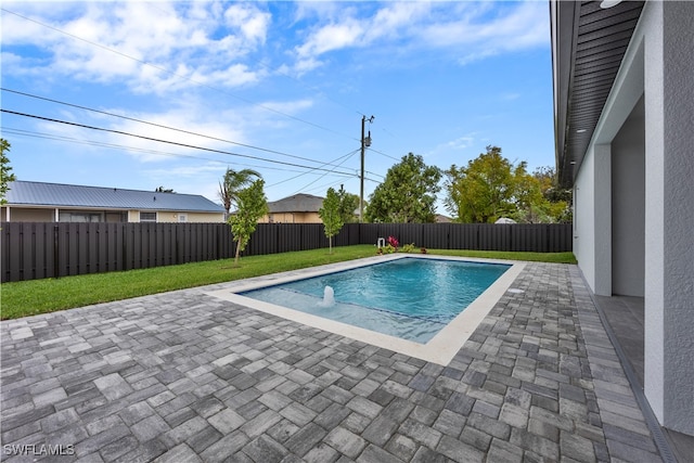 view of swimming pool featuring a patio area and a lawn