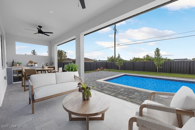 view of swimming pool with ceiling fan, an outdoor hangout area, and a patio area