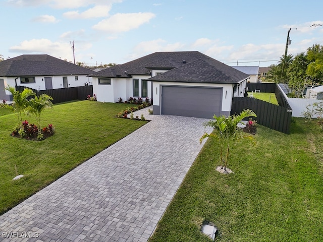 view of front of property with a front lawn and a garage