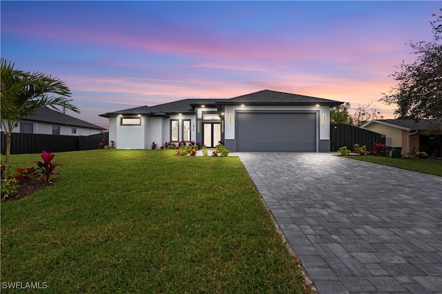 view of front of property with a lawn and a garage