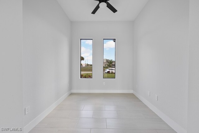 empty room featuring ceiling fan and light tile patterned floors