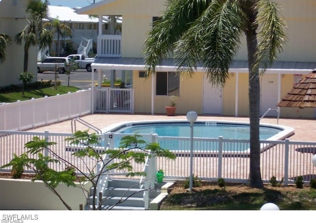 view of swimming pool featuring a patio area