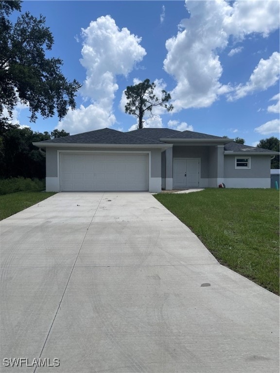 view of front of home featuring a garage and a front lawn