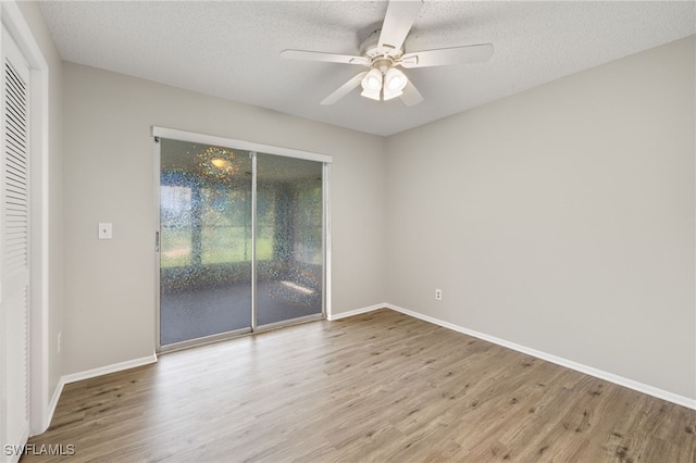 unfurnished room with light hardwood / wood-style flooring, ceiling fan, and a textured ceiling