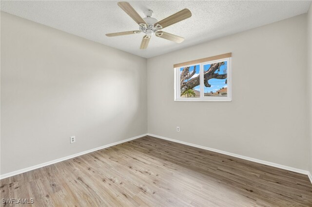 unfurnished room featuring light hardwood / wood-style floors, a textured ceiling, and ceiling fan