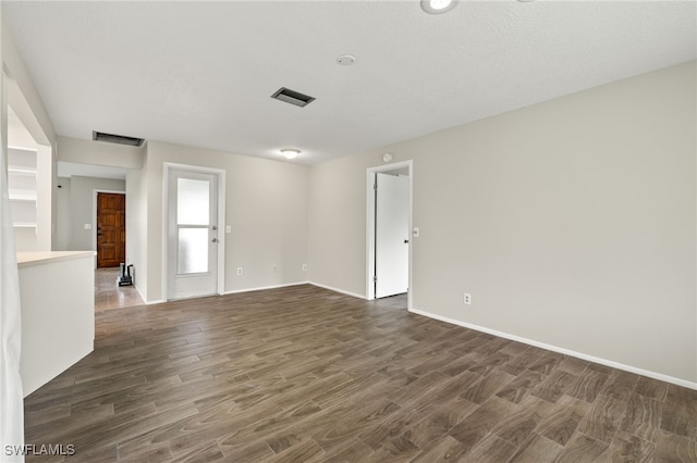 spare room with dark hardwood / wood-style flooring