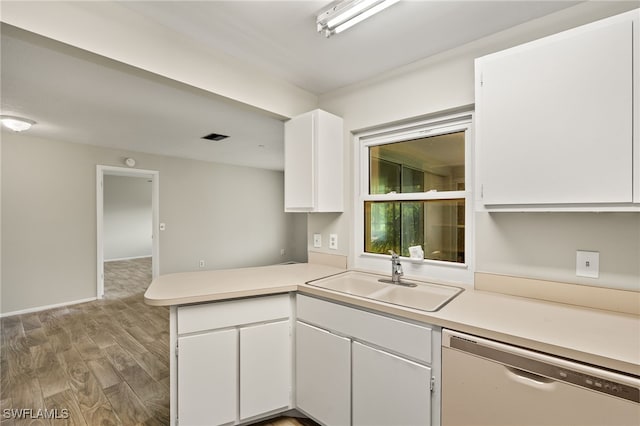 kitchen featuring sink, dishwasher, kitchen peninsula, and white cabinetry