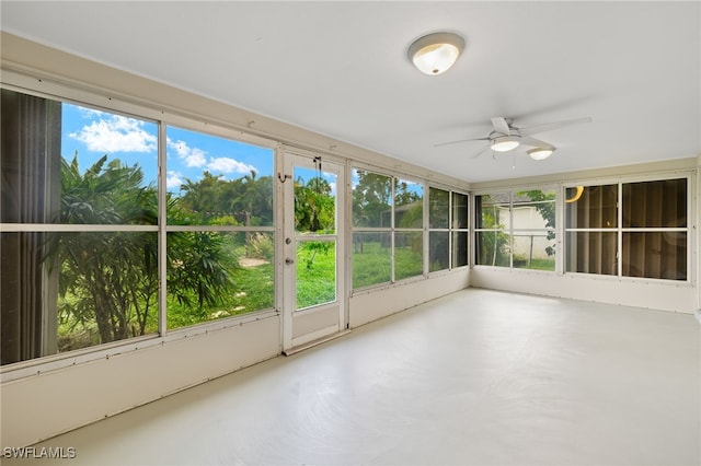 unfurnished sunroom with plenty of natural light and ceiling fan