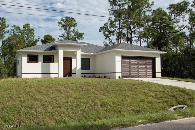 view of front of house featuring a garage and a front yard