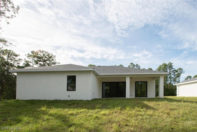 rear view of house with a yard