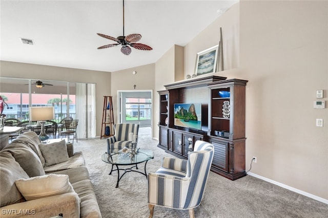 living room with a high ceiling, light colored carpet, and ceiling fan