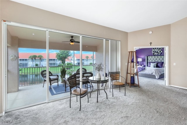 living area featuring carpet floors and ceiling fan