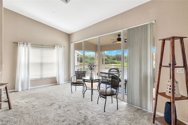 living area featuring lofted ceiling, carpet floors, and ceiling fan