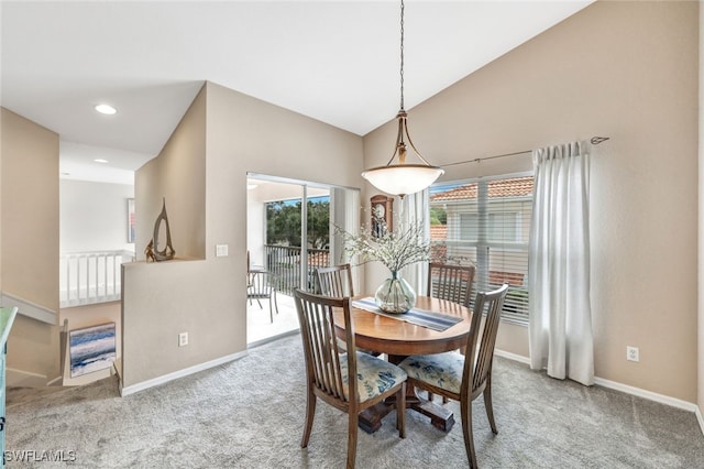 dining room featuring vaulted ceiling and carpet floors