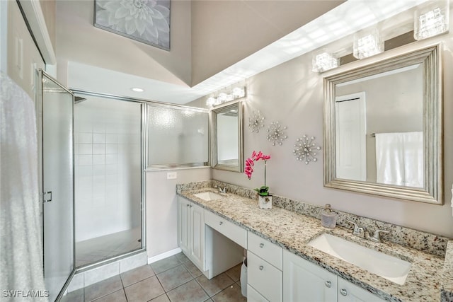 bathroom featuring vanity, tile patterned floors, and a shower with shower door