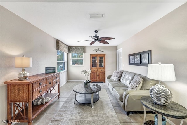 tiled living room with ceiling fan