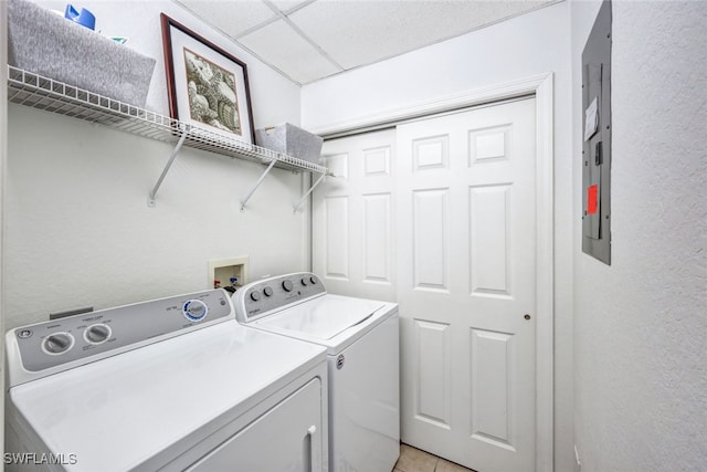 laundry room featuring light tile patterned floors and washing machine and dryer