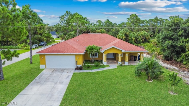 view of front of property with a garage and a front lawn