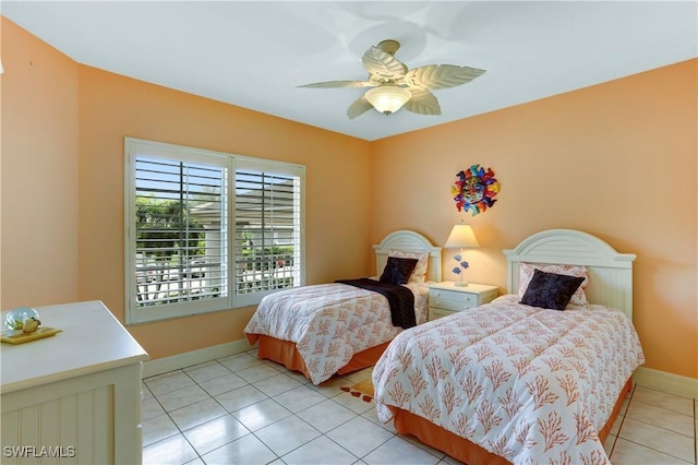 bedroom with a ceiling fan, light tile patterned flooring, and baseboards