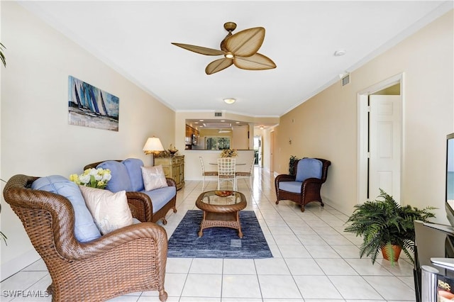 living area with light tile patterned flooring, crown molding, and ceiling fan