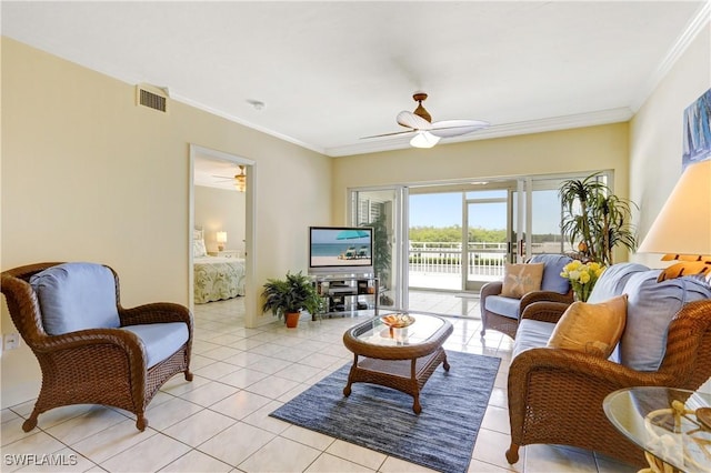 living area featuring ceiling fan, light tile patterned flooring, visible vents, and crown molding