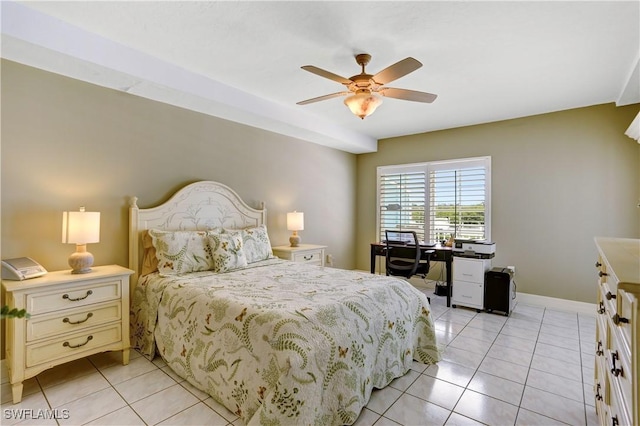 bedroom with light tile patterned floors, a ceiling fan, and baseboards