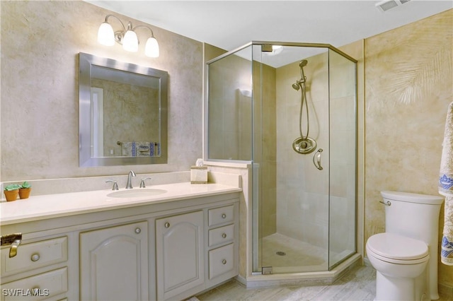 full bathroom featuring a shower stall, visible vents, vanity, and toilet