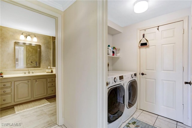 clothes washing area with laundry area, a sink, washer and clothes dryer, and light tile patterned floors