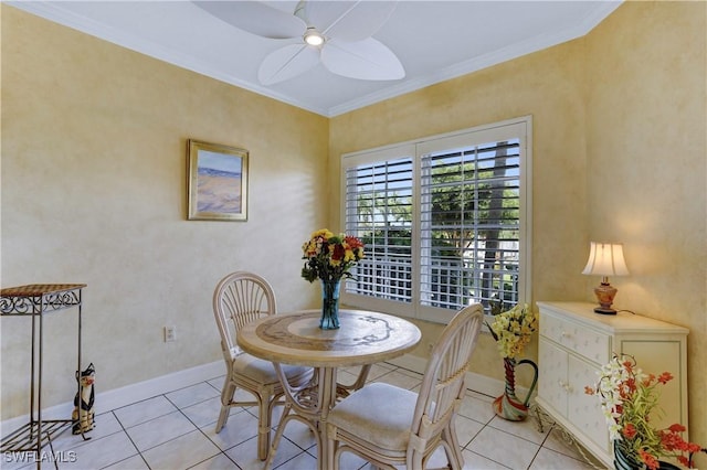 dining space with light tile patterned floors, ceiling fan, ornamental molding, and baseboards