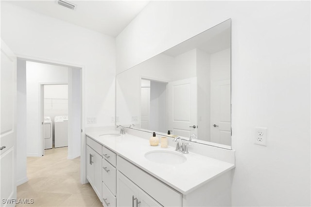 bathroom featuring vanity and washer and clothes dryer