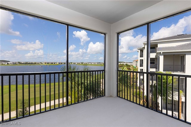 unfurnished sunroom with plenty of natural light and a water view