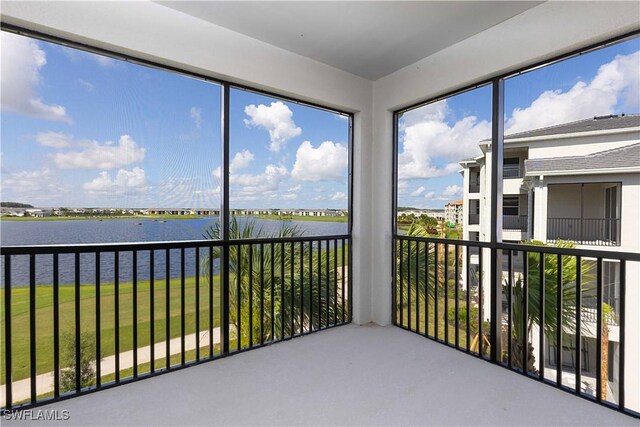5629 Double Eagle Cir Unit 4238, Ave Maria, FL 34142 - unfurnished sunroom featuring a water view