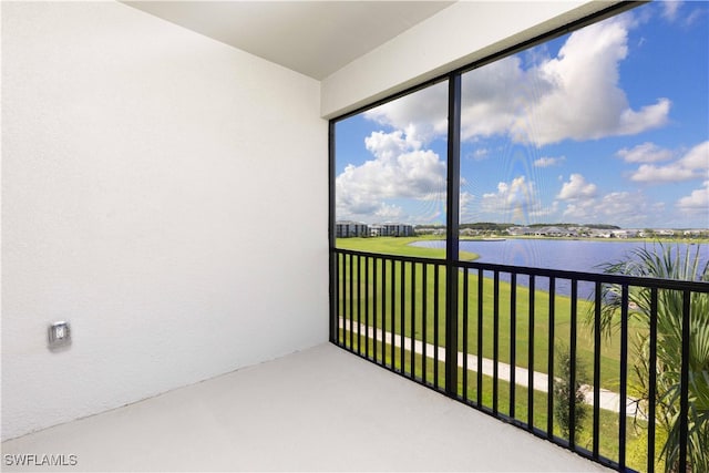 unfurnished sunroom with a water view