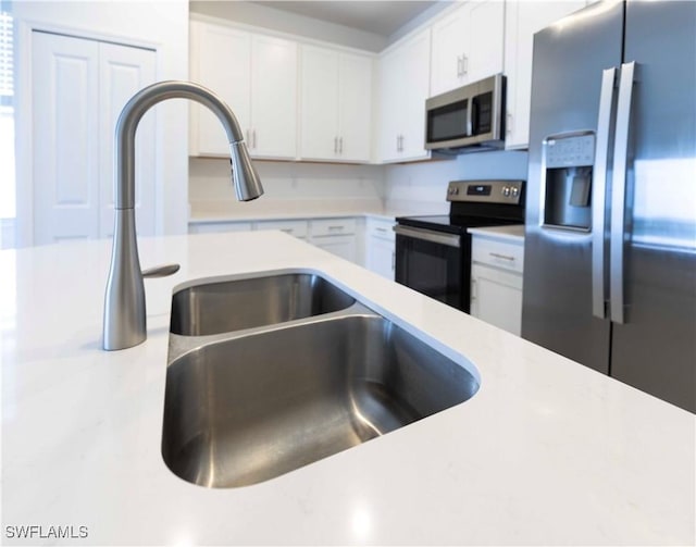 kitchen with stainless steel appliances and white cabinets