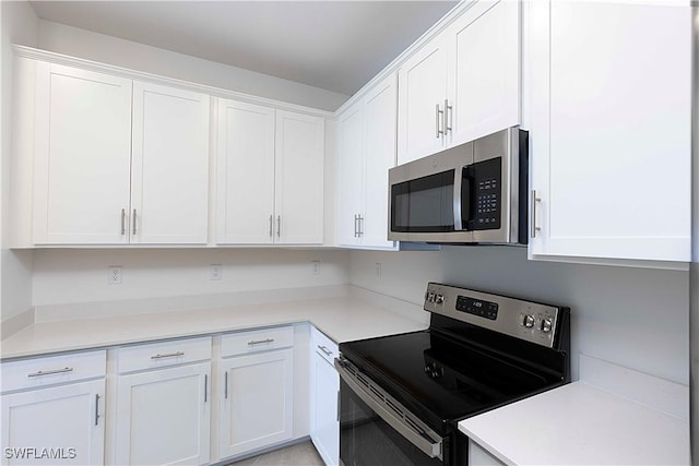 kitchen with white cabinetry and appliances with stainless steel finishes