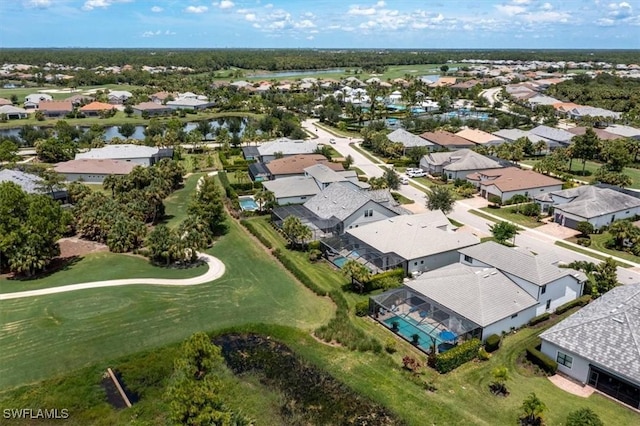 birds eye view of property with a water view and a residential view