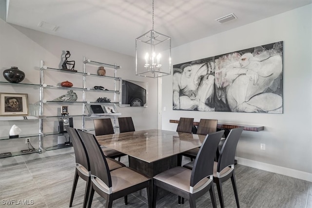 dining area with an inviting chandelier and light hardwood / wood-style floors