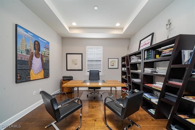 office area featuring baseboards, a tray ceiling, wood finished floors, and recessed lighting