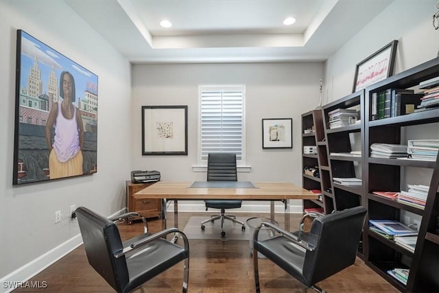 office area with baseboards, a raised ceiling, dark wood-style flooring, and recessed lighting