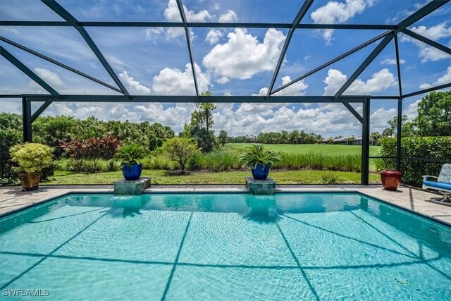 view of swimming pool featuring a lanai and a patio area