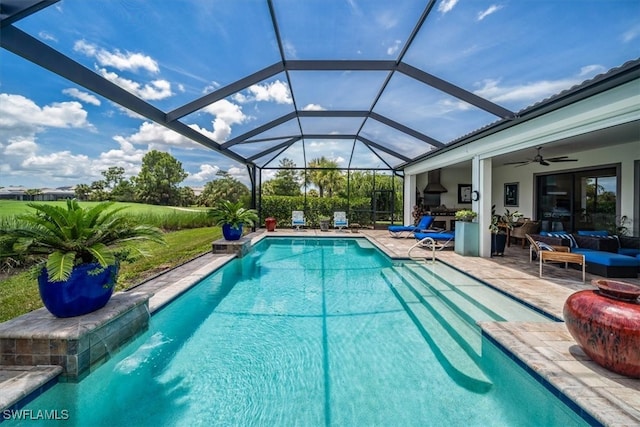 view of swimming pool featuring ceiling fan, a patio area, pool water feature, an outdoor living space, and glass enclosure