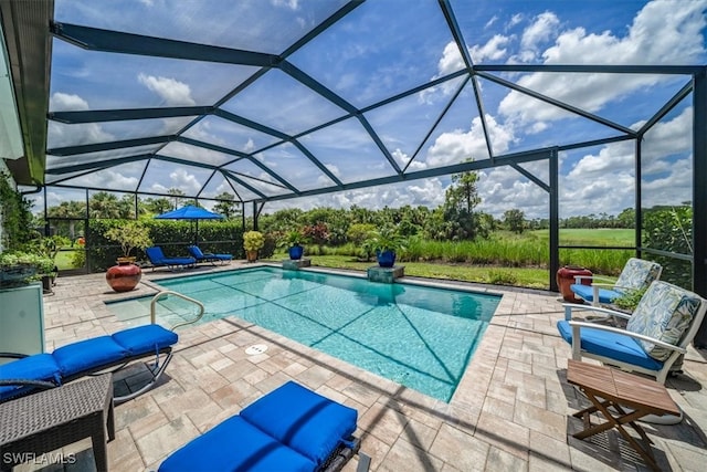 view of swimming pool featuring glass enclosure and a patio area