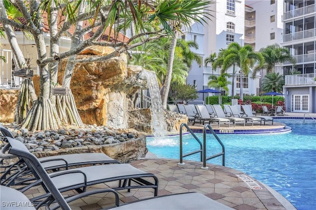 view of swimming pool with pool water feature