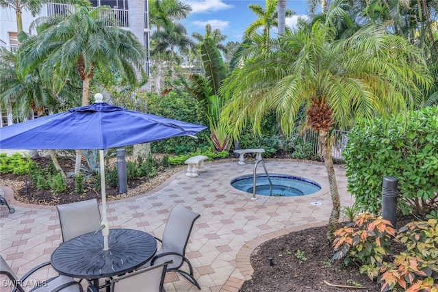 view of patio / terrace with an in ground hot tub