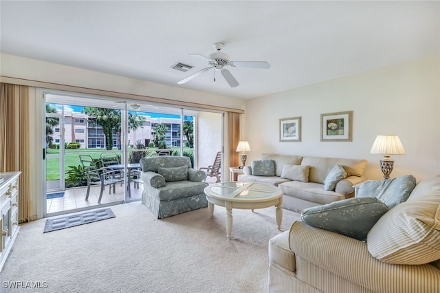 living room with ceiling fan, carpet floors, and a healthy amount of sunlight