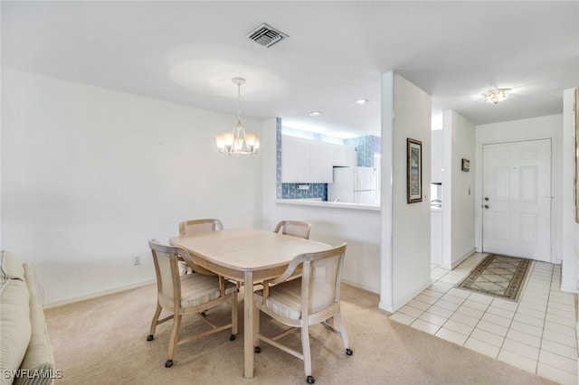 carpeted dining space with an inviting chandelier